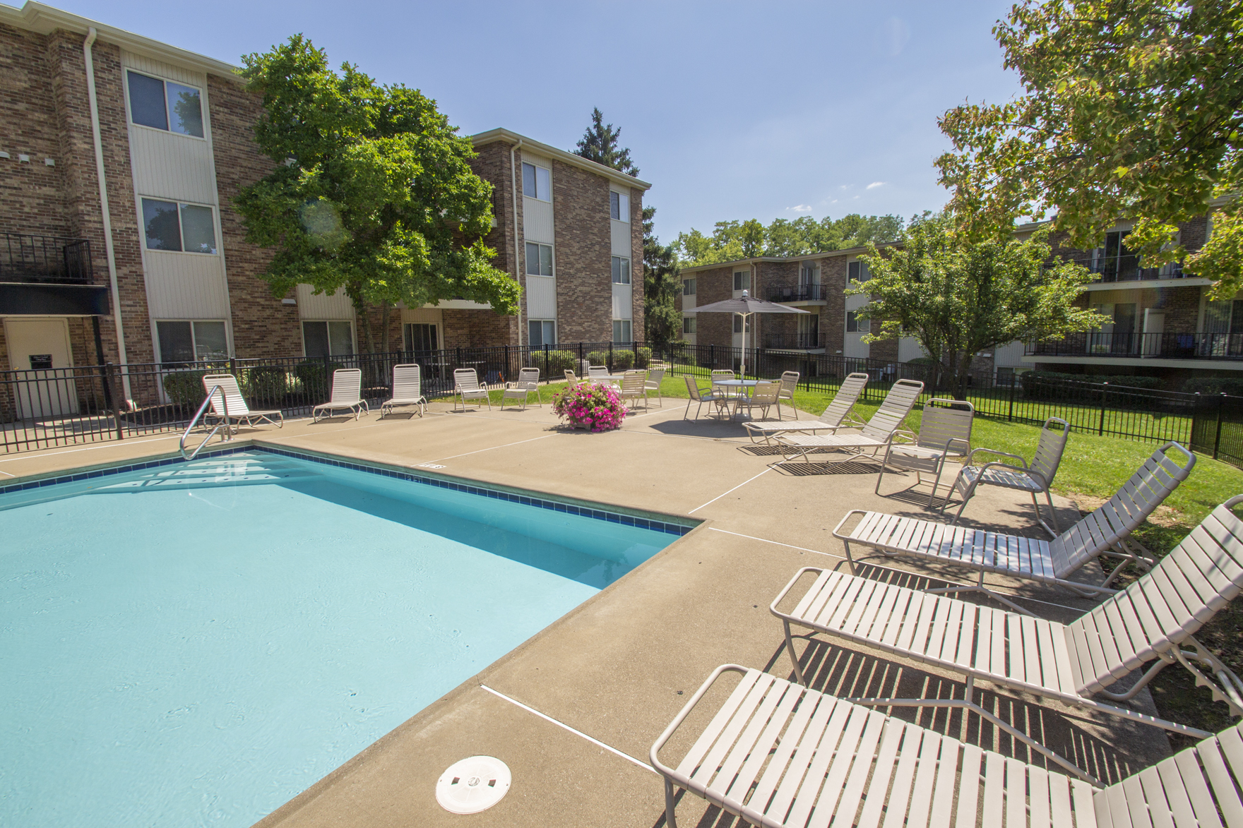 This is a photo of the pool area and building exteriors at Blue Grass Manor Apartments in Erlanger, KY.